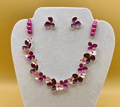 Bib necklace and earring set featuring pink and purple flower petals and colorful crystals.  Each piece has a custom length to fit all sizes.  Necklace is made from glass pearls and crystals to form a unique and stylish look.  Optional bracelet comes with an easy to use magnetic clasp.    I can convert any of the earrings from pierced to clip on style at no charge, please request this in notes with purchase.   Please do not hesitate to contact me with any questions, I would love to hear from you Silver Flower-shaped Metal Jewelry Sets, Pink Metal Jewelry Sets For Gift, Nickel-free Pink Flower-shaped Jewelry, Pink Flower-shaped Jewelry Sets For Gifts, Pink Floral Jewelry Sets For Gifts, Pink Flower-shaped Metal Jewelry, Adjustable Handmade Pink Jewelry Sets, Pink Metal Jewelry For Mother's Day, Mother's Day Pink Metal Jewelry