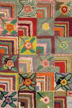 a multicolored patchwork rug with flowers and squares on the bottom, in various colors