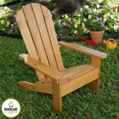 a wooden chair sitting on top of a lush green field