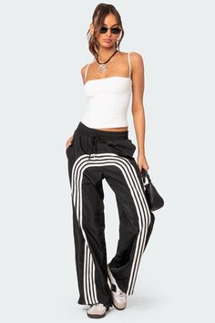 Track pants Contrasting stripes Adjustable tie waist Oversized fit Nylon fabric Polyester Model wears size S Model height is 5'9 Item care: Wash with similar color White Tank Top And Jeans, Tank Top And Jeans, Nylon Track Pants, Legging Court, Trendy Tank Tops, Cropped Camisole, Tracksuit Pants, Swimwear Dress, Nylon Fabric