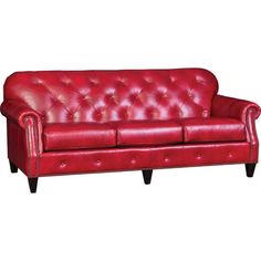 a red leather couch sitting on top of a white floor