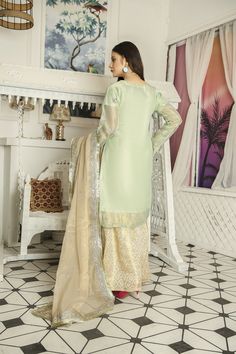 ➤ Mint green embroidered masuri organza kameez, golden jamawar Gharara, golden masuri organza dupatta | Length – Shirt Length 38"; Sharara Length 39.5" with Soft Elastic Belt; Dupatta length 2.18 m Width With Lace 0.89 m & Without Lace 0.85 m ➤ ➤ ➤ ➤ 🌸 Fabric Details - Chiffon, Organza, 🌸 Craft and Decorations - Beautiful Embroideries, embellishments, patches, and laces 🌸 Care - Hand Wash only 🌸 Length & Style - Top ~ 38 - 40 " A-Line/ kurta style, bottom trousers/gharara style, with embroid Gold Organza Lawn Suit With Dabka Work, Gold Unstitched Suit For Eid, Festive Organza Salwar Kameez For Eid, Unstitched Jamawar Lehenga For Party, Gold Anarkali Salwar Kameez In Organza, Gold Organza Kurta With Zari Work, Festive Organza Kurta For Eid, Gold Jamawar Lawn Suit For Festivals, Festive Jamawar Lehenga For Party