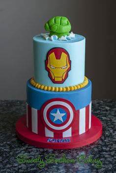 a three tiered cake with captain america decorations