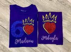 two purple shirts with red and blue glitters on them, one has a heart and the other has a crown