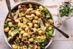 a bowl filled with pasta and meat on top of a table