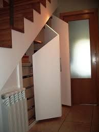 an open door leading to a hallway with white walls and wooden steps, next to a radiator