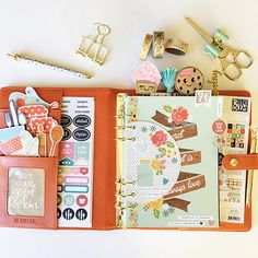 an open planner book sitting on top of a table next to other items and accessories