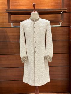 With this gorgeous white embroidered sherwani for men, you can really make a statement on your wedding day! It's a work of art! Beautiful embroidered floral patterns adorn the karandi base, and the ban and cuffs are embellished with hand-stitched zardozi designs. Various zari materials ensure a regal appearance by balancing the color scheme. At [Your Shop Name], we provide a made-to-measure experience while placing a premium on quality. For the ideal fit, be prepared for a measurement form and a Indian Men Sherwani, Wedding Sherwani For Groom, Sherwani For Groom, Men Sherwani, Embroidered Sherwani, Sherwani Groom, Sherwani For Men, Indian Men, Wedding Sherwani