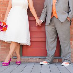 a man and woman standing next to each other holding hands