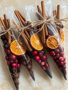 cinnamon sticks, orange slices and cranberries are wrapped in clear cellophane