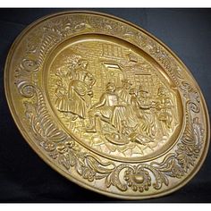 a gold plate with an image of jesus and mary in the center, on a black background