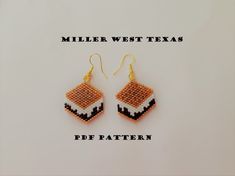 a pair of beaded earrings with the words miller west texas written in black and white