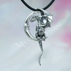 This sterling silver fantasy jewelry pendant features a dragon who has flown so far and high that he has reached the moon, where he's taking a moment to rest and visit with his celestial friend. This unique Lunar Dragon Pendant is sure to delight any lover of fantasy jewelry. This dragon and moon dimensional pendant was created using the lost-wax casting method. After various designs and sketches were completed the dragon and moon were sculpted out of wax. This process takes many enjoyable hours Fantasy Silver Jewelry With Moon Charm, Silver Dragon Design Jewelry For Fantasy Events, Silver Pendant Jewelry For Fantasy Events, Silver Pendant Necklace For Fantasy Events, Dragon And Moon, Lunar Dragon, Fantasy Pendant, Crescent Moon Pendant, Dragon Necklace