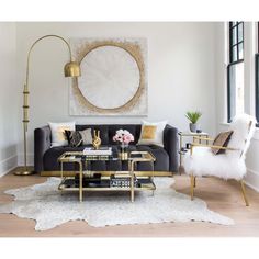 a living room filled with furniture and a painting on the wall