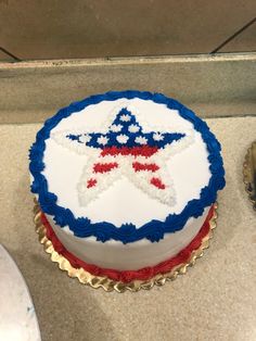 a cake with red, white and blue icing on it sitting on a counter