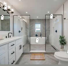 a bathroom with a large walk in shower next to a white toilet and bathtub