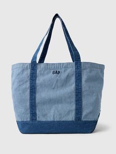 Soft cotton denim tote bag.  Shoulder straps at top.  Inner pocket with zipper.  Embroidered mini Gap arch logo at front.  Responsibly Made: This denim bag s is part of our water-saving Washwell program.  Compared with conventional wash methods, Washwell uses at least 20% less water and has saved over a billion liters of water since 2016.  This product was made in a factory that invests in gender equality and women’s empowerment.  Through RISE Reimagining Industry to Support Equality) and Gap In Tote Bag With Pins, Tote Bags With Zipper, Tote Bag With Zipper, Aesthetic Tote Bag, Knitting Tote Bag, Gap Logo, Arch Logo, Jean Crafts, Denim Tote Bags