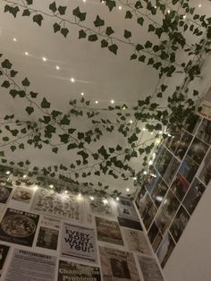 the ceiling is covered with ivy vines and lite - up photos from years ago