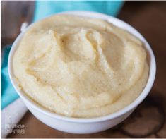 a white bowl filled with mashed potatoes on top of a table