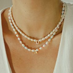 Dress in elegance with our Personalized Rainbow Initial Necklace, featuring natural pearls and colorful seed beads. Ideal for daily wear or thoughtful gifting, this piece combines timeless beauty with a playful touch. *Personalized pieces take between 2-4 business days to ship* Handcrafted in USADETAILS: Material: Freshwater pearls, gold-filled clasp, stainless steel letters Skin Friendly ALL LETTERS ARE CAPITAL-Length 15 inches + 2-inch adjustable extender chain Note: you can add more letters, numbers, and charms, by looking for our Add-ons Collection and following the instructions. Everyday Handmade Pearl Beaded Necklaces, Multicolor Beaded Necklace With Pearl Chain As Gift, Pearl Necklace With Letter Beads As Gift, Pearl Necklace With Letter Beads For Gift, Gift Pearl Necklace With Colorful Beads, Pearl Necklace With Colorful Beads For Gift, Pearl Necklace With Letter Beads And Round Beads, White Pearl Necklace With Colorful Beads As Gift, Elegant Multicolor Beaded Necklaces For Everyday