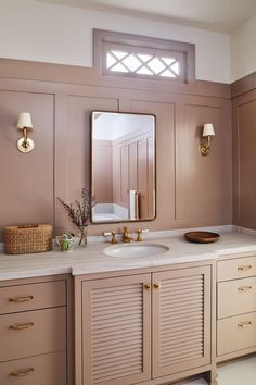 a bathroom with two sinks and a large mirror on the wall over it's vanity