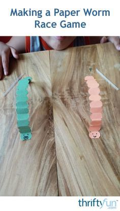 a child making a paper worm race game on a wooden table with text overlay that reads, making a paper worm race game