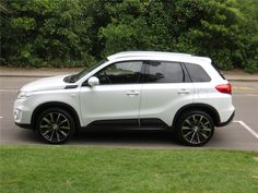 a white suv parked in a parking lot