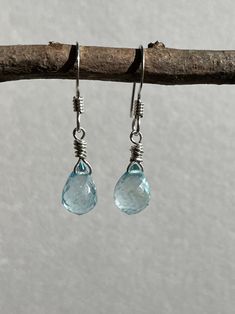 "Blue Topaz Earrings, Sky Blue Teardrop Earrings in Sterling silver, December Birthstone, Sterling silver Jewelry, Gift for Mom These dainty and classic earrings feature generous size perfect faceted Sky blue topaz briolettes wire wrapped sterling silver. The elegant mysterious blue earrings are suspended from sterling silver French hooks Earwires.  Ideal for an anniversary gift or a December Birthday gift, or that perfect soft color earring to never take off, these crystal clear blue earrings are a forever piece of jewelry that can remain in your family for generations to come.  About These Earrings: * Stone: Sky Blue Topaz * Birthstone Month: December * Stone Size: 10 mm x 8 mm * Earrings Length: 1&1/4\" * Finish: Sterling silver  * Secure Lever Back Ear Wires  * Gift Wrapping Included * Sterling Silver Briolette Teardrop Gemstone Earrings, Silver Aquamarine Dangle Earrings, Silver Topaz Teardrop Earrings, Silver Teardrop Topaz Earrings, Silver Briolette Earrings With Birthstone, Silver Aquamarine Gemstone Earrings, Silver Briolette Blue Topaz Jewelry, Silver Blue Topaz Briolette Jewelry, Nickel-free Blue Topaz Dangle Earrings