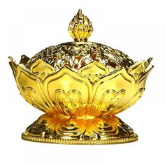 a golden bowl sitting on top of a metal stand with a gold crown on it