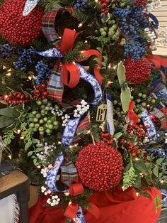 a christmas tree decorated with red, white and blue ribbons