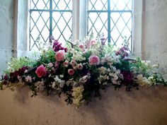 a window sill filled with lots of flowers