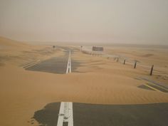 an empty road in the middle of desert with no cars or people driving on it