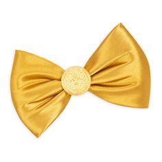 a gold bow tie with a medallion on it