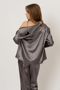 Be cocooned in a soft, sumptuous feel fabric. The perfect set for rest and relaxation, the luxe three-piece pajama set features a bra top with V-neckline, matching pants, and long sleeve pajama shirt.

 The matching bra top features a V-neckline, cropped, triangle silhouette, and adjustable straps.
The matching pants feature a high-waisted, relaxed silhouette and ribboned waist.
The pajama shirt comes in satin and features an oversized, longline silhouette, button-down closure, and V-neckline. Elegant V-neck Loungewear Sets, Elegant Lounging Sets With Long Pants, Elegant Long Sleeve Sleepwear Set, Chic Long Sleeve Sleepwear For Pajama Party, Chic Blouse For Loungewear, Elegant Solid Color Loungewear Sets, Chic Solid Color Blouse For Loungewear, Chic Solid Blouse For Loungewear, Elegant Long Sleeve Sleep Tops