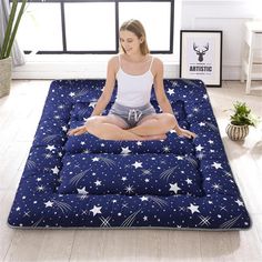 a woman is sitting on an inflatable mattress with stars and sparkles all over it