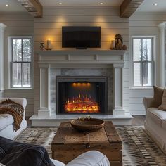 a living room with a fire place and couches in front of the fireplace,