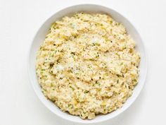 a white bowl filled with food on top of a table