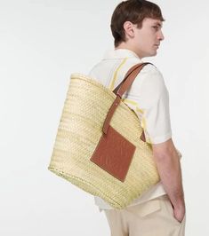 Displaying the label's penchant for artisanal design, this tote bag from Loewe has been crafted in Spain featuring a hand-woven raffia body, leather top handles and an embossed, tan leather Anagram patch..Made in Spain.Designer color name: Natural/Tan.Trim: calf leather.Comes with dust bag.Color of fastening: silver.Closure: open top.Adjustable shoulder strap.Height 35cm-14'.Min. width 32cm-12.5'.Max. width 58cm-23'.Depth 17cm-6.5'.Min. length of handles 46cm-18'.Max. length of handles 53cm-21' Designer Woven Straw Tote Bag, Designer Handwoven Tote Bags, Designer Handwoven Tote Shoulder Bag, Loewe Bags, Raffia Tote Bag, Tan Trim, Artisanal Design, Loewe Bag, Woven Raffia