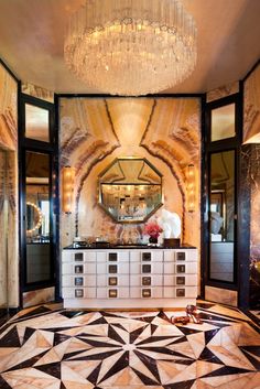 a fancy bathroom with marble flooring and chandelier hanging from the ceiling above it