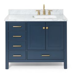 a bathroom vanity with marble top and gold handles on the drawers, along with two faucets