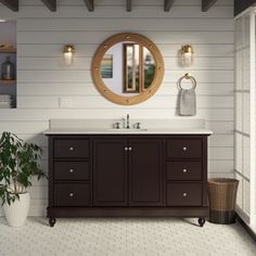 a bathroom with a sink, mirror and potted plant on the floor in front of it