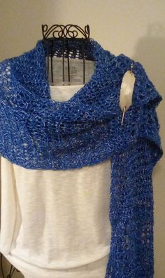 HAND CROCHETED SHAWL, WRAP, SCARF IN ROYAL BLUE AND WHITE This is a beautiful shawl made with a fine acrylic yarn. It is very big and can be worn in so many different ways. Since it is lightweight, it can be worn for all seasons. The color is blue with white running through it.  It measures approximately 16 ins. wide and 64 ins. long. Looks great with jeans and light enough to wear inside during the winter. Hand wash, lay flat to dry. A great gift! SHAWL PIN NOT INCLUDED. All items made in a smo Blue Hand Knitted Winter Shawl, Hand Knitted Blue Winter Shawl, Hand Knitted Blue Shawl For Winter, Handmade Blue Shawl For Winter, Blue Crochet Shawl One Size, Hand Knitted Blue Shawl One Size, Blue Shawl Wrap, Blue Crochet Yarn Shawl, Crocheted Shawl