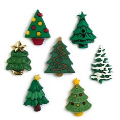 christmas tree cookies are arranged on a white surface