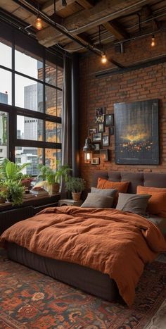 an industrial bedroom with brick walls and floor to ceiling windows that overlook the cityscape