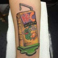 a tattoo on the arm of a person with an orange juice can in front of it