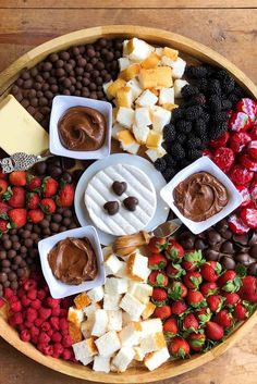 a platter filled with chocolate, fruit and cheese