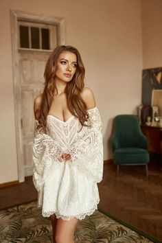 a beautiful young woman posing in a white dress