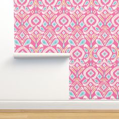 a pink and blue wallpaper with an abstract design on the wall next to a white door