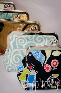 three purses with different designs on them