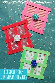 three popsicle stick christmas presents on a table